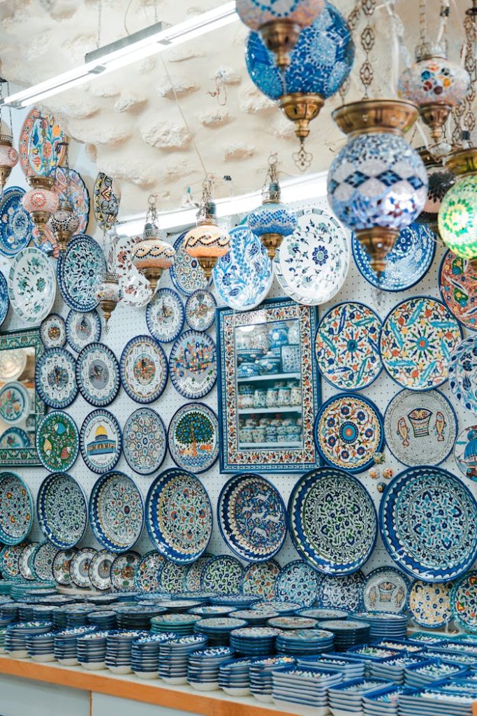 Beautiful ceramic plates and lamps on display at a Jerusalem market shop. Vibrant colors and intricate designs.